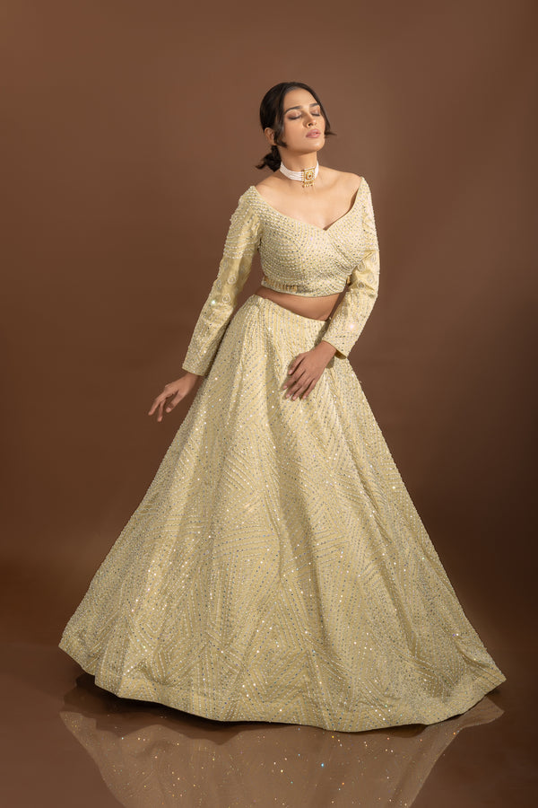 Royal Weaves: Lavish Beige Silk Designer Lehenga Choli with Pearls and Mirrors