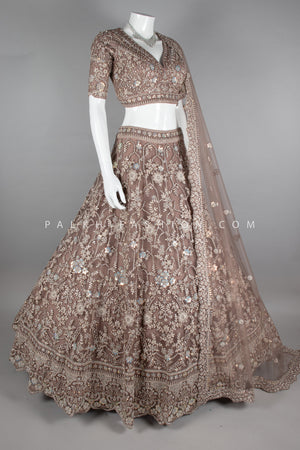 Graceful Grandeur: Soft Amber Lehenga Choli with Embroidery & Handwork