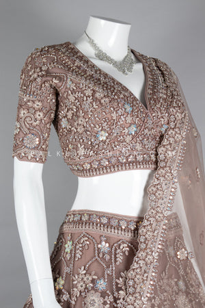 Graceful Grandeur: Soft Amber Lehenga Choli with Embroidery & Handwork