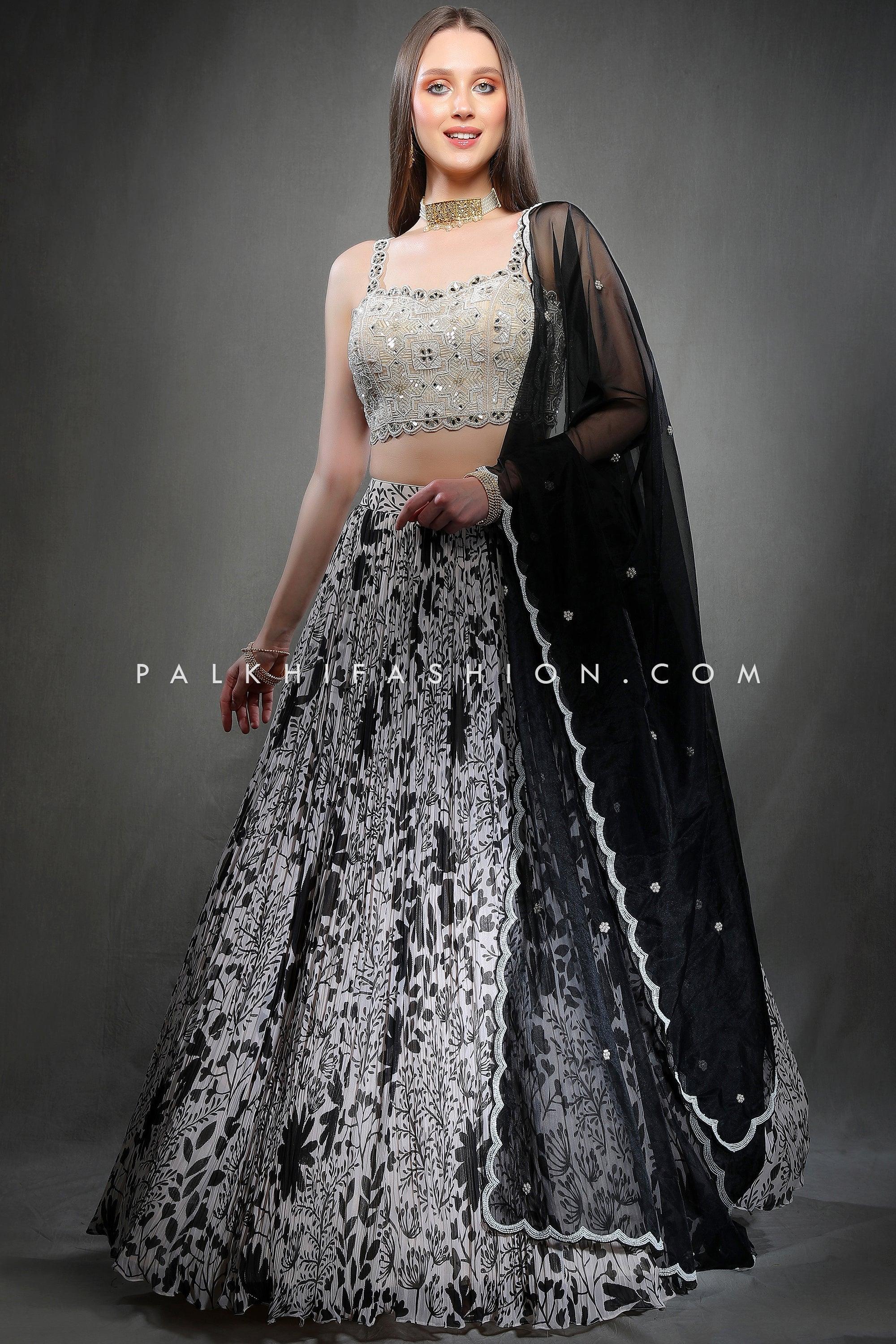 IVORY WHITE SHIMMERY COCKTAIL LEHENGA SET WITH A HAND EMBROIDERED MIRROR  WORK BLOUSE PAIRED WITH A MATCHING FRILL DUPATTA AND SILVER EMBELLISHMENTS.  - Seasons India